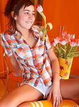 Curly redhead teenie posing on the table